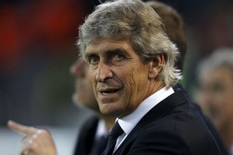 Malaga's coach Pellegrini is pictured before Champions League quarter-final second leg soccer match against Borussia Dortmund in Dortmund...Malaga's coach Manuel Pellegrini is pictured before the Champions League quarter-final second leg soccer match against Borussia Dortmund, in the western German city of Dortmund April 9, 2013.      REUTERS/Ina Fassbender (GERMANY  - Tags: SPORT SOCCER)