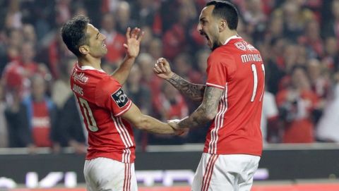 Benfica's Jonas, left, and Kostas Mitroglou celebrate after winning a penalty shot during a Portuguese league soccer match between Benfica and FC Porto at the Luz stadium in Lisbon, Saturday, April 1, 2017. (AP Photo/Armando Franca)