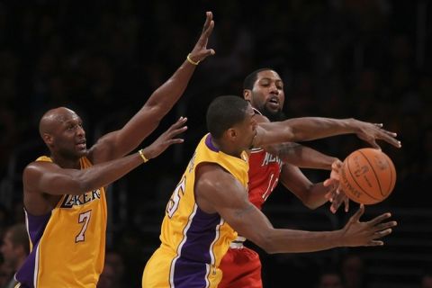 LOS ANGELES, CA - DECEMBER 21:  (L-R) Lamar Odom #7 and Ron Artest #15 of the Los Angeles Lakers defend John Salmons #15 of the Milwaukee Bucks during the first half at Staples Center on December 21, 2010 in Los Angeles, California. NOTE TO USER: User expressly acknowledges and agrees that, by downloading and or using this photograph, User is consenting to the terms and conditions of the Getty Images License Agreement.  (Photo by Jeff Gross/Getty Images)