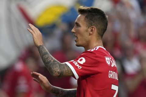 Benfica's Goncalo Ramos, left, celebrates with Benfica's Alex Grimaldo after scoring his side's second goal during the Champions League, third qualifying round, first leg soccer match between Benfica and Midtjylland at the Luz stadium in Lisbon, Portugal, Tuesday, Aug. 2, 2022. (AP Photo/Armando Franca)