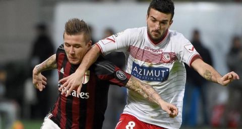 AC Milan's midfielder Kuraj Kucka (L) struggles for the ball with Carpi's midfielder Raffaele Bianco during their Italy Cup quarterfinal at the Giuseppe Meazza stadium in Milan, Italy, 13 January 2016. ANSA/DANIEL DAL ZENNARO