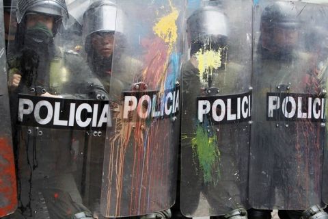 Riot policemen stand guard, with shields splattered with paint from protesters, during a demonstration in Bogota April 7, 2011. Thousands of students and teachers marched in a nation wide protest against the education government's reform of public universities, student organizations reported. REUTERS/John Vizcaino (COLOMBIA - Tags: POLITICS EDUCATION CIVIL UNREST)