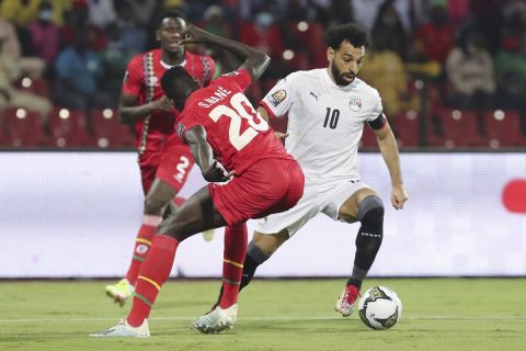 Egypt's Mohamed Salah in action by Soriano Mane of Guinea-Bissau during the African Cup of Nations Group D soccer match between Egypt and Guinea-Bissau in Garoua, Cameroon, Saturday, Jan. 15, 2022. (AP Photo/Footografiia)