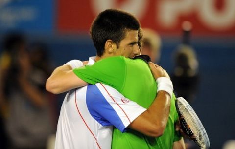 Novak Djokovic of Serbia (L) embraces Andy Murray of Britain (R) after Djokovic won their men's singles final on the fourteenth day of the Australian Open tennis tournament in Melbourne on January 30, 2011.  Djokovic won 6-4, 6-2, 6-3.  MAGE STRICTLY RESTRICTED TO EDITORIAL USE  STRICTLY NO COMMERCIAL USE   AFP PHOTO / GREG WOOD (Photo credit should read GREG WOOD/AFP/Getty Images)