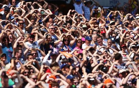 LONDON, ENGLAND - JULY 27:  Spectators perfomr the Mo Farah  'MoBot' celebration  during day two of the Sainsbury's Anniversary Games - IAAF Diamond League 2013 at The Queen Elizabeth Olympic Park on July 27, 2013 in London, England.  (Photo by Paul Gilham/Getty Images)