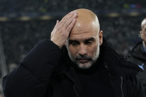 Manchester City's head coach Pep Guardiola arrives at the pitch ahead of the Champions League, opening phase soccer match between Juventus and Manchester City at the Allianz stadium in Turin, Italy, Tuesday, Wednesday, Dec.11, 2024. (AP Photo/Luca Bruno)