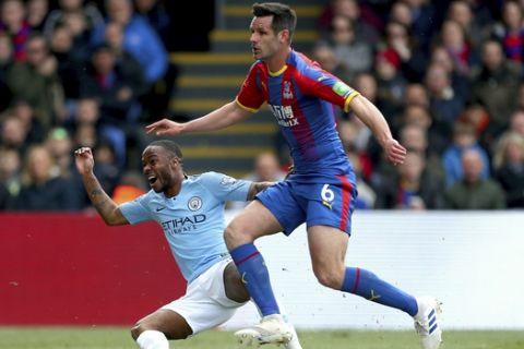 Manchester City's Raheem Sterling, left, celebrates scoring his side's first goal of the game during their English Premier League soccer match against Crystal Palace at Selhurst Park, London, Sunday, April 14, 2019. (Steven Paston/PA via AP)