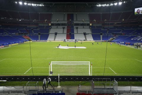 A view of the empty Groupama stadium during the half time break of the French League One soccer match between Lyon and Reims, in Lyon, France, Wednesday, Dec. 1, 2021. The match is being played behind closed doors as a sanction against Lyon after a supporter threw a bottle at a Marseille player a week ago. (AP Photo/Laurent Cipriani)