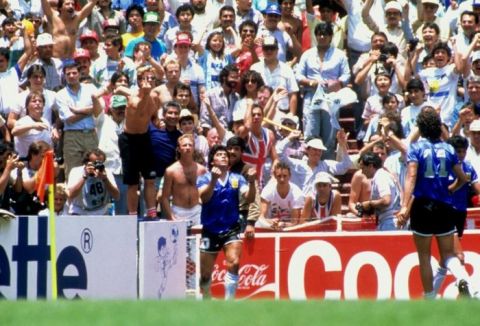 England fans look on as Diego Maradona of Argentina celebrates his second goal