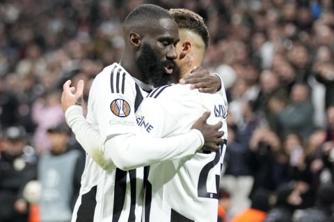 Besiktas' Ernest Muci celebrates with teammate Besiktas' Arthur Masuaku, left, after scoring the opening goal during the Europa League opening phase soccer match between Besiktas and Malmo at the Besiktas stadium in Istanbul, Turkey, Wednesday, Nov. 6, 2024. (AP Photo/Khalil Hamra)