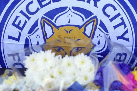 Tributes are placed outside Leicester City Football Club, Leicester, England, Monday Oct. 29, 2018, after a helicopter crashed in flames Saturday. Vichai Srivaddhanaprabha, the Thai billionaire owner of Premier League team Leicester City was among five people who died after his helicopter crashed and burst into flames shortly after taking off from the soccer field, the club said Sunday. (AP Photo/Rui Vieira)