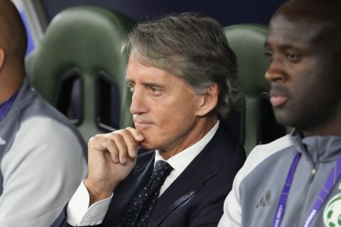 Saudi Arabia's head coach Roberto Mancini sits in his team dugout prior to the Asian Cup round of 16 soccer match between Saudi Arabia and South Korea at Education City Stadium Al Rayyan, Qatar, Tuesday, Jan. 30, 2024. (AP Photo/Aijaz Rahi)