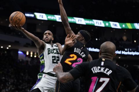 Milwaukee Bucks' Khris Middleton shoots past Miami Heat's Jimmy Butler during the second half of an NBA basketball game Wednesday, March 2, 2022, in Milwaukee. The Bucks won 120-119. (AP Photo/Morry Gash)