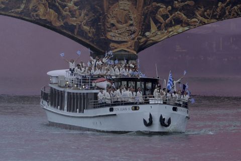 Athletes of Greece aboard a boat as it makes its way along the Seine in Paris, France, during the opening ceremony for the 2024 Summer Olympics, Friday, July 26, 2024. (Ann Wang/Pool Photo via AP)