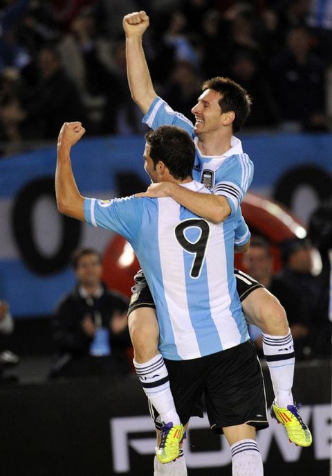 Argentina's Gonzalo Higuain (front) and teammate Lionel Messi celebrate after scoring their team´s fourth goal against Chile during a Brazil 2014 World Cup South American qualifier match held at the Monumental stadium in Buenos Aires on October 7, 2011. Argentina won 4-1.   AFP PHOTO / DANIEL GARCIA (Photo credit should read DANIEL GARCIA/AFP/Getty Images)