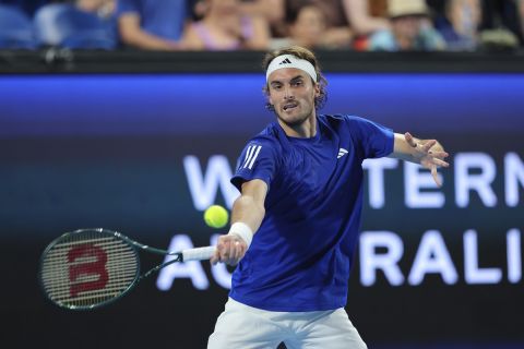 Stefanos Tsitsipas of Greece hits a return shot to Pablo Carreno Busta of Spain during their United Cup tennis match in Perth, Australia, Saturday, Dec. 28, 2024. (AP Photo/Trevor Collens)