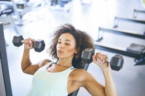 Young Woman Weightraining at the Gym