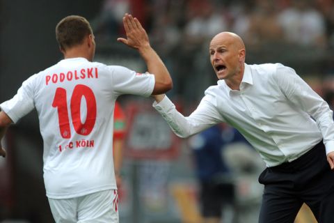 RESTRICTIONS / EMBARGO - DFL LIMITS THE USE OF IMAGES ON THE INTERNET TO 15 PICTURES (NO VIDEO-LIKE SEQUENCES) DURING THE MATCH AND PROHIBITS MOBILE (MMS) USE DURING AND FOR FURTHER TWO HOURS AFTER THE MATCH. FOR MORE INFORMATION CONTACT DFL. 
Cologne's striker Lukas Podolski (L) is congratulated by Cologne's Norwegian head coach  Stale Solbakken after scoring a goal during the German first division Bundesliga football match Bayer 04 Leverkusen vs 1.FC Cologne in the western German city of Leverkusen on September 17, 2011. 
AFP PHOTO / PATRIK STOLLARZ (Photo credit should read PATRIK STOLLARZ/AFP/Getty Images)