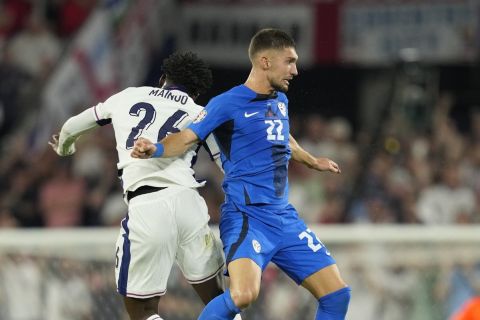 England's Kobbie Mainoo jumps for a header with Slovenia's Adam Gnezda Cerin during a Group C match between the England and Slovenia at the Euro 2024 soccer tournament in Cologne, Germany, Tuesday, June 25, 2024. (AP Photo/Andreea Alexandru)