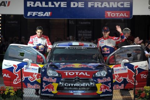 France's rally driver  Sebastien Ogier (R) and his co-driver France's Julien Ingrassia wave to the public during the start ceremony of France's Rally, on September 29, 2011  in Strasbourg, eastern France. The Rallye de France Alsace  starts on September 30, 2011.  AFP PHOTO / FREDERICK FLORIN (Photo credit should read FREDERICK FLORIN/AFP/Getty Images)