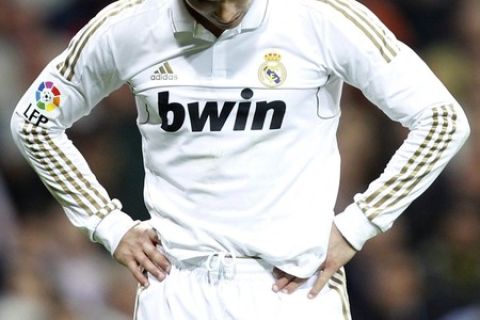 Real Madrid's Cristiano Ronaldo reacts after missing a chance to score against Valencia during their Spanish first division soccer match at Santiago Bernabeu stadium in Madrid April 8, 2012.  REUTERS/Sergio Perez  (SPAIN - Tags: SPORT SOCCER)