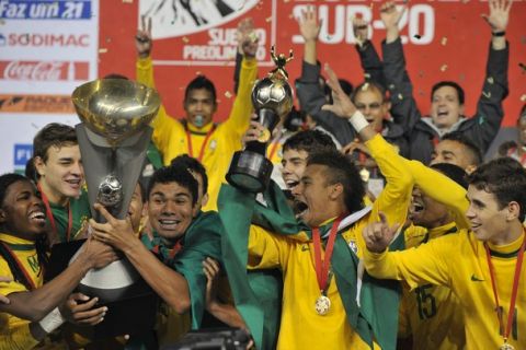 The COMEBOL trophy is held by players as Brazil's midfielder Neymar holds his Best Player trophy surrounded by teammates celebrating after a steaming closing game defeating Uruguay 6-0 and winning the final-round matches of the Under-20 South American championship at the UNSA Stadium in Arequipa, 1,000 km south of Lima, on February 12, 2011. By winning the tournament Brazil will participate in both the Olympic Games and the FIFA Under-20 World Cup.     AFP PHOTO/Cris BOURONCLE (Photo credit should read CRIS BOURONCLE/AFP/Getty Images)