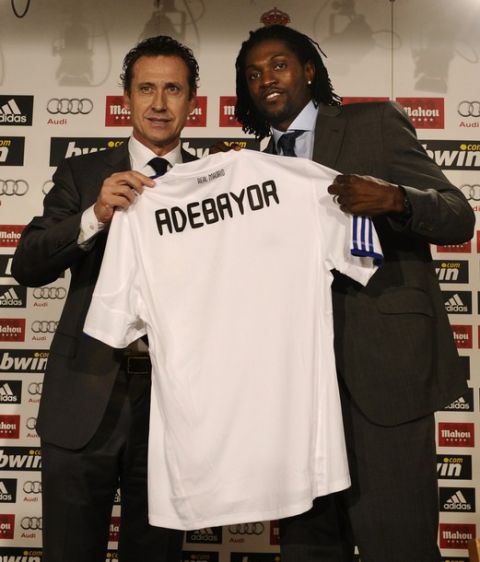 New Real Madrid's Togolese striker Emmanuel Adebayor (R) poses with his new jersey and Real Madrid's Argentinian General Manager Jorge Valdano during his presentation to medias on January 27, 2011 at the Santiago Bernabeu stadium in Madrid. The 26-year-old has been brought in to add urgently needed firepower after Argentinian striker Gonzalo Higuain underwent surgery to fix a slipped disc earlier this month and is expected to be out of action for another four months.    AFP PHOTO/ PIERRE-PHILIPPE MARCOU (Photo credit should read PIERRE-PHILIPPE MARCOU/AFP/Getty Images)