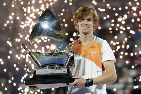 Russia's Andrey Rublev holds the trophy after defeating Czech Republic's Jiri Vesely during the final match of the Dubai Duty Free Tennis Championship in Dubai, United Arab Emirates, Saturday, Feb. 26, 2022. (AP Photo/Ebrahim Noroozi)