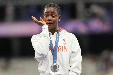 Women's 400-meter silver medalist Salwa Eid Naser, of Bahrain, wipes away tears while standing on the podium at the 2024 Summer Olympics, Friday, Aug. 9, 2024, in Saint-Denis, France. (AP Photo/Bernat Armangue)