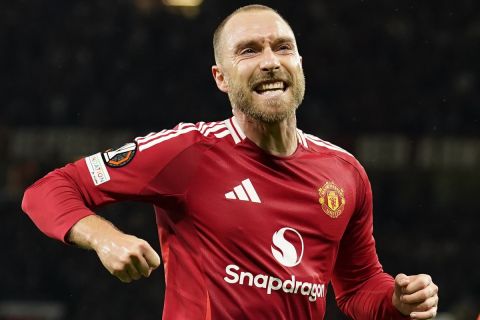 Manchester United's Christian Eriksen celebrates after scoring the opening goal during the Europa League opening phase soccer match between Manchester United and Twente in Manchester, England, Wednesday, Sept. 25, 2024. (AP Photo/Dave Thompson)