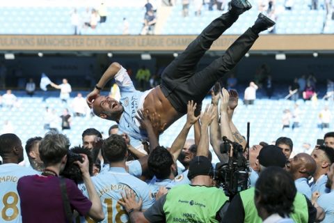 Manchester City manager Pep Guardiola is thrown up into the air by players after the English Premier League soccer match between Manchester City and Huddesfiel at the Etihad Stadium, in Manchester, England, Sunday May 6, 2018. (Martin Rickett/PAvia AP)