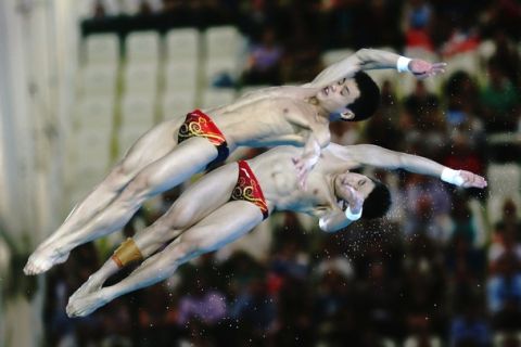 LONDON, ENGLAND - JULY 30:  Yuan Cao and Yanquan Zhang of China compete in the Men's Synchronised 10m Platform Diving on Day 3 of the London 2012 Olympic Games at the Aquatics Centre on July 30, 2012 in London, England.  (Photo by Clive Rose/Getty Images)