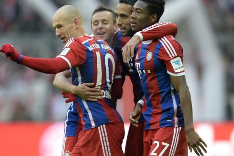 (LtoR) Bayern Munich's Dutch midfielder Arjen Robben, Bayern Munich's Brazilian defender Rafinha, Bayern Munich's Moroccan Mehdin Benatia and Bayern Munich's Austrian defender David Alaba celebrate after the third goal for Munich during  the German first division Bundesliga football match FC Bayern Munich vs Hamburger SV at the Allianz Arena in Munich, southern Germany, on February 14, 2015. 
AFP PHOTO / CHRISTOF STACHE

RESTRICTIONS - DFL RULES TO LIMIT THE ONLINE USAGE DURING MATCH TIME TO 15 PICTURES PER MATCH. FOR FURTHER QUERIES PLEASE CONTACT DFL DIRECTLY AT + 49 69 650050        (Photo credit should read CHRISTOF STACHE/AFP/Getty Images)