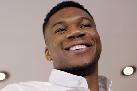 NBA star Giannis Antetokounmpo, smiles during a press conference by Greece's Tourism Ministry to promote his native Greece, in Athens, on Friday, June 29, 2018. Antetokounmpo, whose parents immigrated to Greece from Nigeria, said he always encourages his friends to visit but his favorite part of the country is Athens, where he grew up. (AP Photo/Petros Giannakouris)