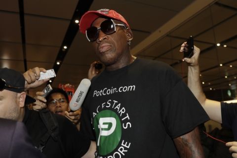 Former NBA basketball player Dennis Rodman arrives at Singapore's Changi Airport on Tuesday, June 12, 2018. (AP Photo/Wong Maye-E)