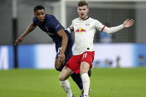 Leipzig's Timo Werner, right, and Tottenham's Japhet Tanganga challenge for the ball during the Champions League round of 16, 2nd leg soccer match between RB Leipzig and Tottenham Hotspur in Leipzig, Germany, Tuesday, March 10, 2020. (AP Photo/Michael Sohn)