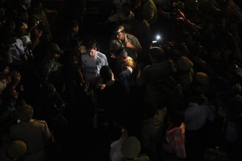 Argentine footballer Lionel Messi(C) walks into a stadium for a practise session as fans gather to have a glimpse of him ahead of a match in Kolkata on September 01, 2011. Argentina 's football team, lead by the newly elected captain Lionel Messi, came to Kolkata to play in the first ever FIFA Friendly International Match on the Indian subcontinent against Venezuela on September 02, 2011. AFP PHOTO/Dibyangshu SARKAR (Photo credit should read DIBYANGSHU SARKAR/AFP/Getty Images)