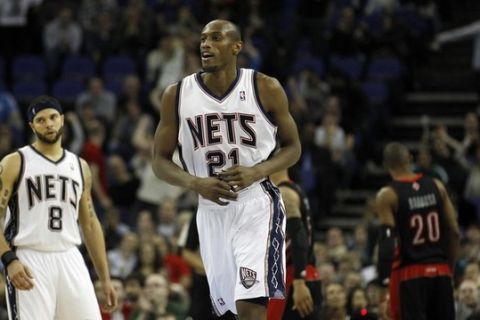 New Jersey Nets forward Travis Outlaw (21) celebrates after scoring against the Toronto Raptors during triple overtime in their NBA game in London March 5, 2011. REUTERS/Suzanne Plunkett (BRITAIN - Tags: SPORT BASKETBALL)