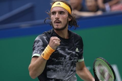 Stefanos Tsitsipas of Greece reacts as he plays against Novak Djokovic of Serbia during the men's singles quarterfinals match at the Shanghai Masters tennis tournament at Qizhong Forest Sports City Tennis Center in Shanghai, China, Friday, Oct. 11, 2019. (AP Photo/Andy Wong)