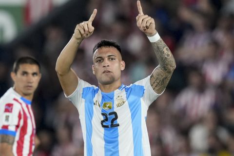 Argentina's Lautaro Martinez celebrates scoring the opening goal against Paraguay during a qualifying soccer match for the FIFA World Cup 2026 in Asuncion, Paraguay, Thursday, Nov. 14, 2024. (AP Photo/Jorge Saenz)