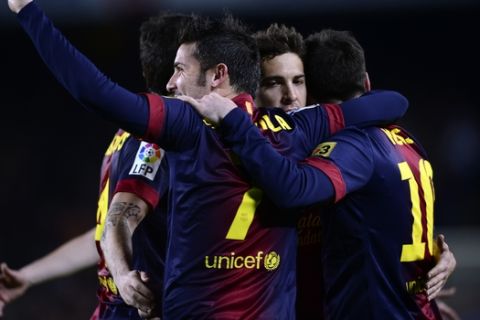 FC Barcelona's Lionel Messi, from Argentina, right, reacts after scoring with his teamamte Jordi Alba, center,and David Villa, left, against Rayo Vallecano during a Spanish La Liga soccer match at the Camp Nou stadium in Barcelona, Spain, Sunday, March 17, 2013. (AP Photo/Manu Fernandez)