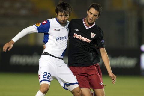 Spanish Athletic Clubs Erik Moran (R) is challenged by Israeli Hapoel Kiryat Shmonas midfielder Darko Tasevski (L) during their UEFA Europa League Group I qualifying football match at the Kiryat Eliezer Stadium in the Mediterranean coastal city of Haifa on November 28, 2012. AFP PHOTO / JACK GUEZ        (Photo credit should read JACK GUEZ/AFP/Getty Images)