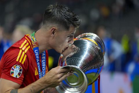 Spain's Alvaro Morata kisses the trophy after winning the final match between Spain and England at the Euro 2024 soccer tournament in Berlin, Germany, Sunday, July 14, 2024. (AP Photo/Martin Meissner)