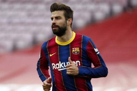 Barcelona's Gerard Pique runs for the ball during the Spanish La Liga soccer match between FC Barcelona and Celta at the Camp Nou stadium in Barcelona, Spain, Sunday, May. 16, 2021. (AP Photo/Joan Monfort)