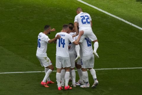 Slovakia players celebrate after teammate Slovakia's Ivan Schranz scored the opening goal during the Group E match between Belgium and Slovakia at the Euro 2024 soccer tournament in Frankfurt, Germany, Monday, June 17, 2024. (AP Photo/Themba Hadebe)