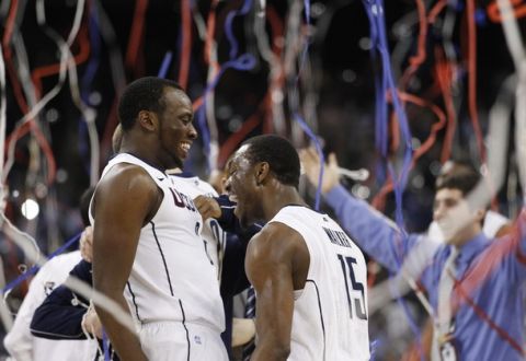 Connecticut Huskies guard Donnell Beverly (L) and teammate Kemba Walker celebrate defeating the Butler Bulldogs in their men's final NCAA Final Four College Championship basketball game in Houston, Texas, April 4, 2011. REUTERS/Jeff Haynes (UNITED STATES - Tags: SPORT BASKETBALL)