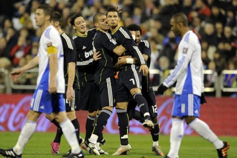 Real Madrid's Portuguese forward Cristiano Ronaldo (C) celebrates after scoring their second goal during the Spanish League football match Zaragoza against Real Madrid at the La Romareda stadium in Zaragoza, on December 12, 2010. AFP PHOTO/JAVIER SORIANO. (Photo credit should read JAVIER SORIANO/AFP/Getty Images)