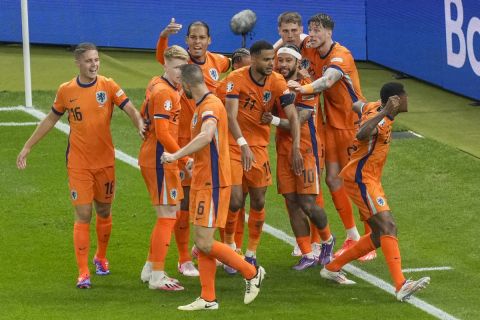 Cody Gakpo of the Netherlands, center, celebrates with his teammates after scoring his sides second goal during a quarterfinal match between the Netherlands and Turkey at the Euro 2024 soccer tournament in Berlin, Germany, Saturday, July 6, 2024. (AP Photo/Markus Schreiber)