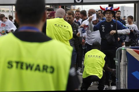 Security check fans hours before the start of the UEFA Nations League soccer match between France and Denmark at the Stade de France in Saint Denis near Paris, France, Friday, June 3, 2022. (AP Photo/Jean-Francois Badias)