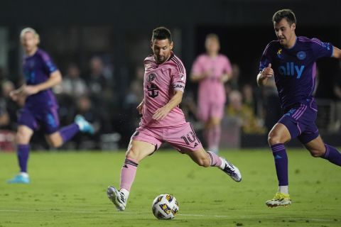 Inter Miami forward Lionel Messi (10) takes a shot, pursued by Charlotte FC midfielder Andrew Privett (34) during the first half of an MLS soccer match, Saturday, Sept. 28, 2024, in Fort Lauderdale, Fla. (AP Photo/Rebecca Blackwell)